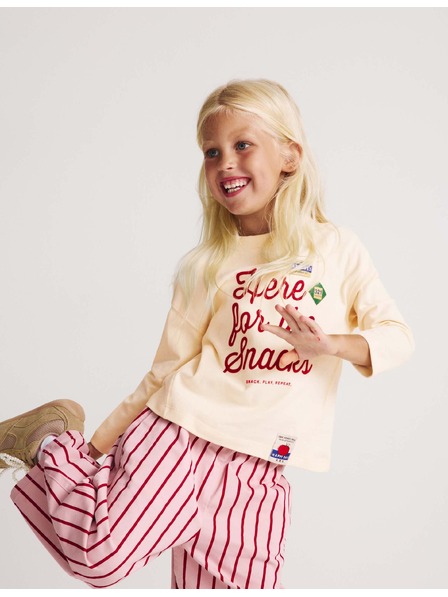 Marks & Spencer Top z čisté bavlny s nápisem „For The Snacks“ (2–8 let) Marks & Spencer smetanová