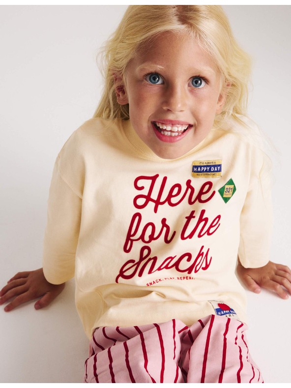 Marks & Spencer Top z čisté bavlny s nápisem „For The Snacks“ (2–8 let) Marks & Spencer smetanová